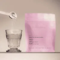 The Skinny Confidential Beauty Salt pink packaging with glass and spoon. The Skinny Confidential Beauty Salt pink packaging with glass and spoon.