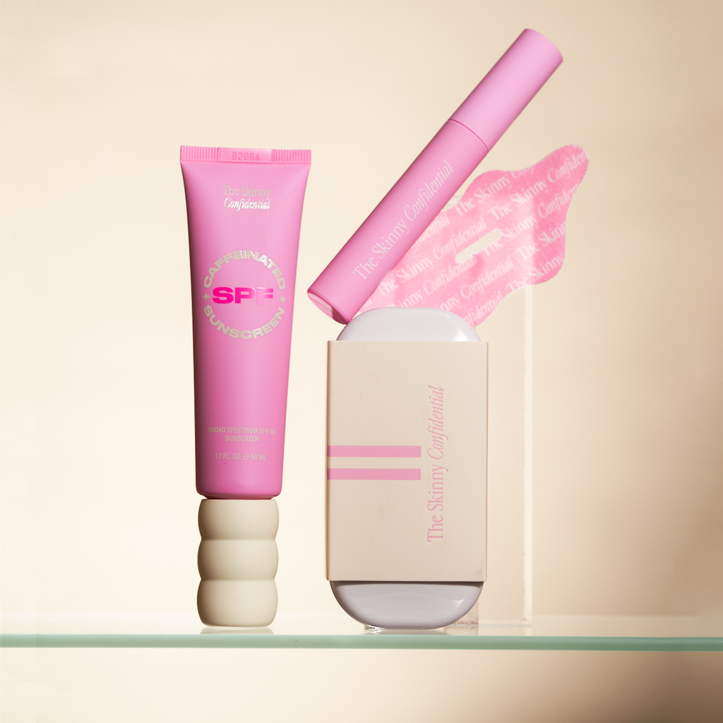 Pink skincare products display including sunscreen and lip balm.