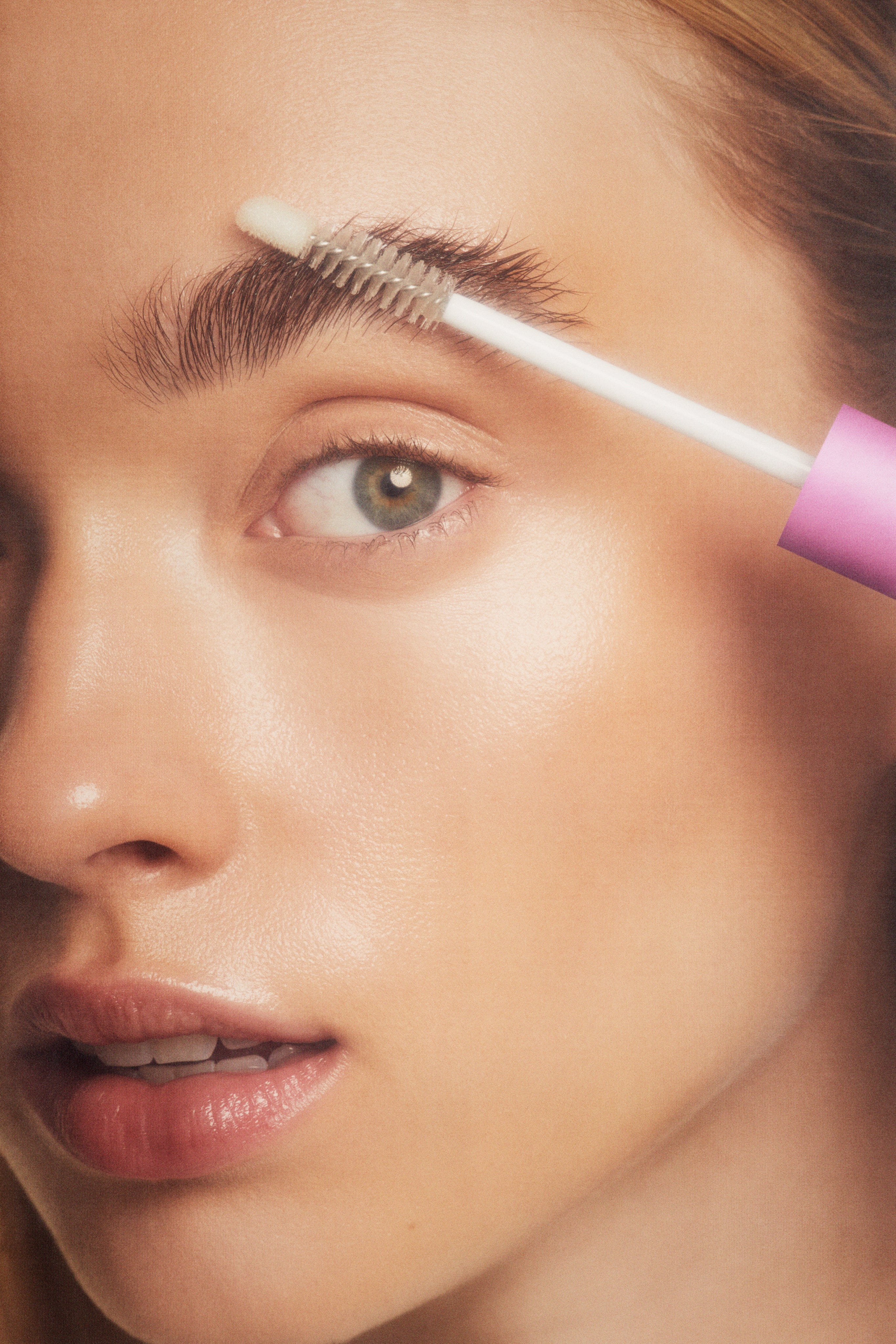 person applying eyebrow gel closeup